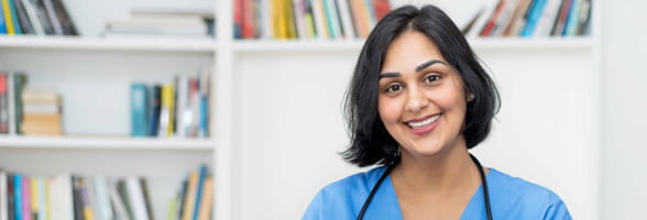 Smiling female nurse with file of patient